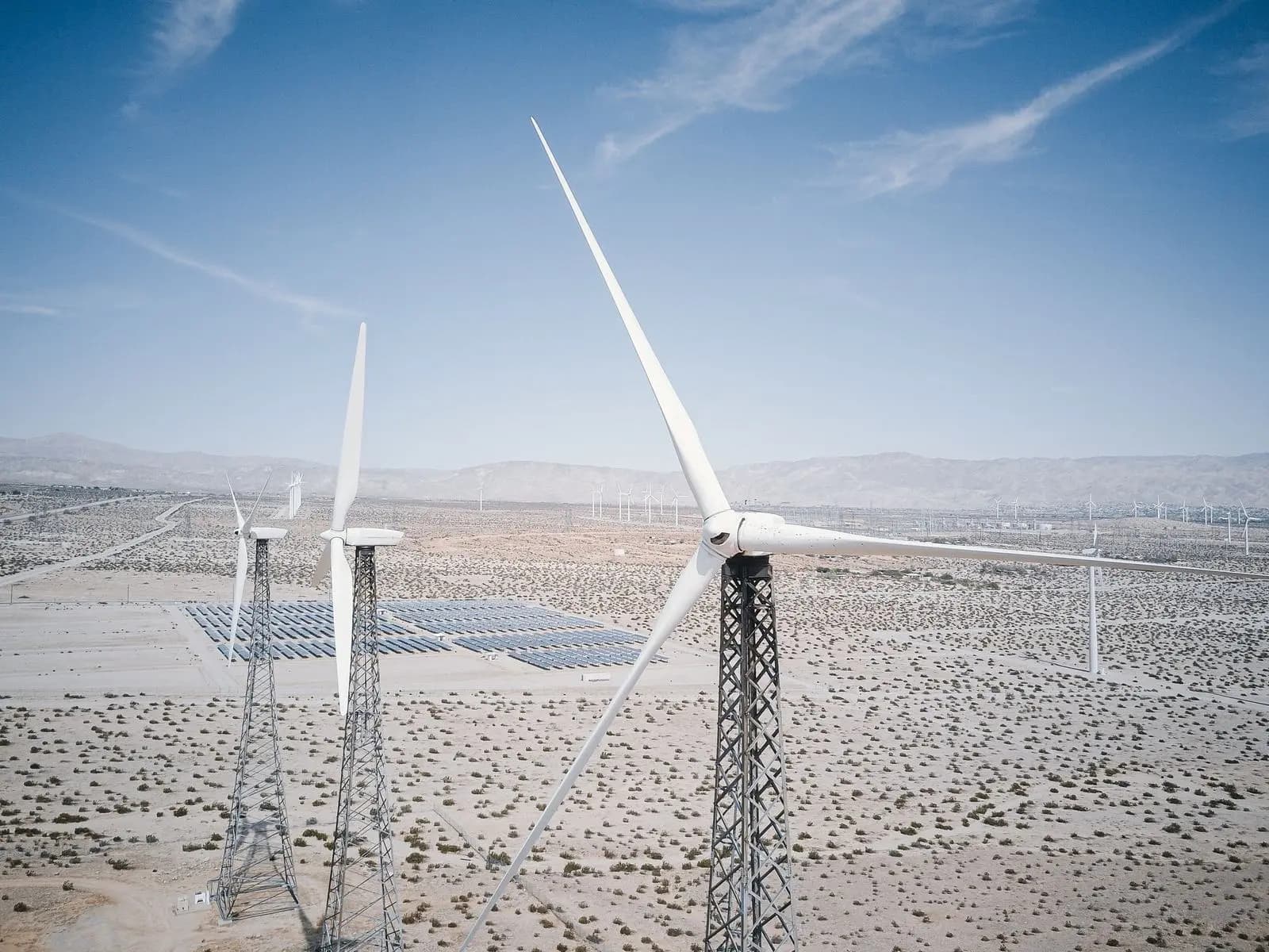 Wind turbines and a solar field in the desert