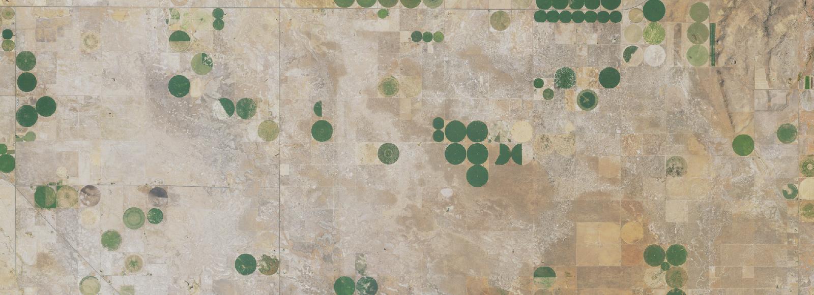 Aerial view of section-line terrain in the Harney Basin, the kind of ground a land position is built from.